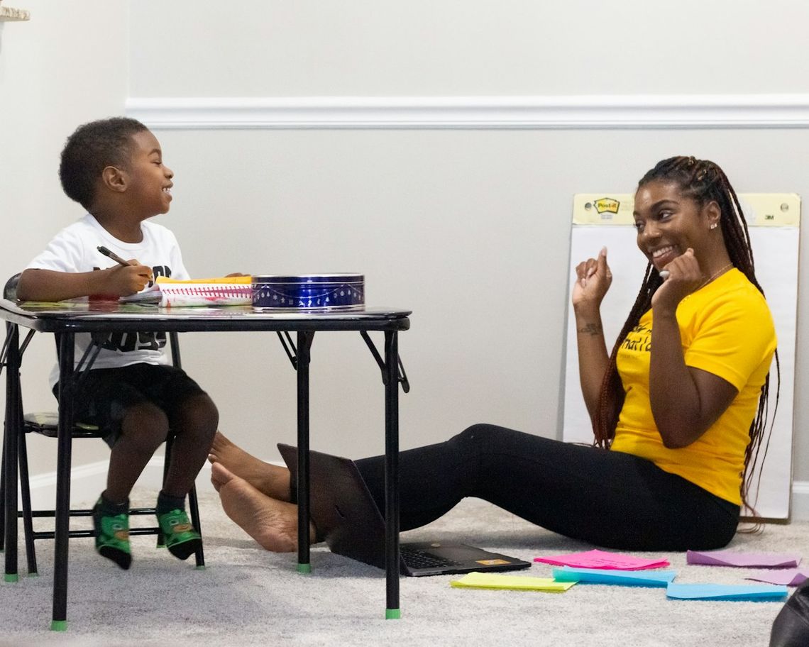 A teacher and a young student enjoying an extra class at home